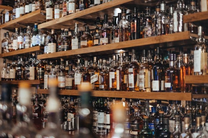 Estante com uma quantidade grande de bebidas alcoolicas